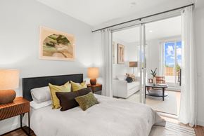 Woodstock apartment for rent - A bedroom with a large bed and a painting on the wall.