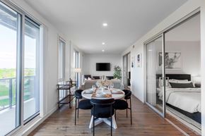 Woodstock apartment for rent - A modern dining room with a table set for two and a bedroom in the background.