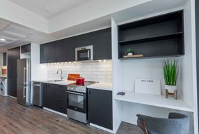 Woodstock apartment for rent - A modern kitchen with black cabinets and a white countertop.