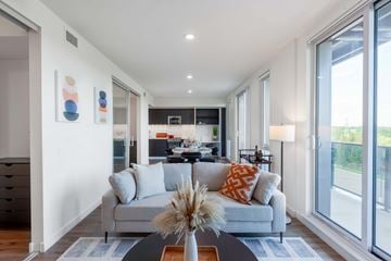 Woodstock apartment for rent - A modern living room with a grey couch and a coffee table.