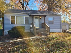 Berkeley house for rent - a small blue house with a wooden porch and a tree