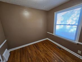 Berkeley house for rent - a bedroom with wood floors and a large window