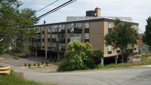 Halifax apartment for rent - A large building with a flat roof and a balcony on the second floor.