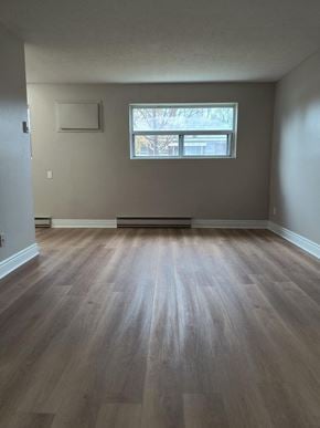 Brantford apartment for rent - A room with a window and wooden flooring.