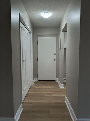 Brantford apartment for rent - A long hallway with a white door at the end.