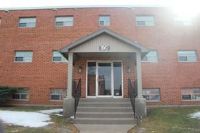 Brantford apartment for rent - The front of a red brick building with the number 108 on it.