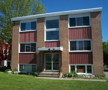 Halifax apartment for rent - A red and white building with a glass door and windows.