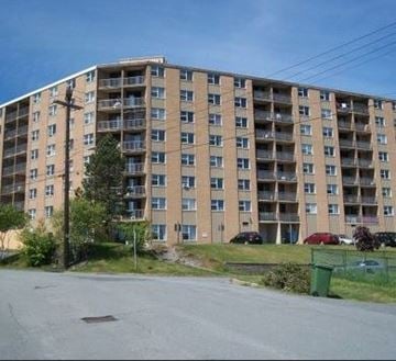 Halifax apartment for rent - A large apartment building with a parking lot in front.
