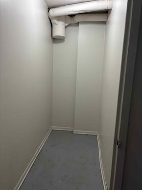 Halifax apartment for rent - A white pipe runs along the wall of a narrow room.