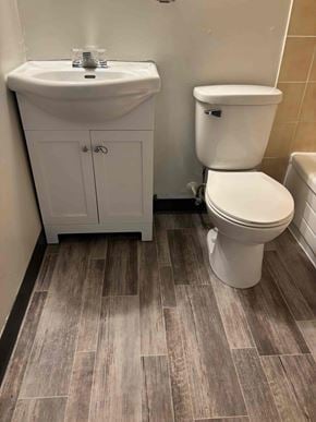 Halifax apartment for rent - A white toilet sits next to a sink in a bathroom.