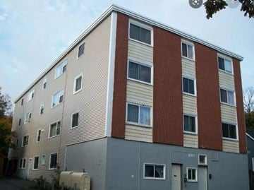 Halifax apartment for rent - A multi-story building with a mix of beige and red brick facades.