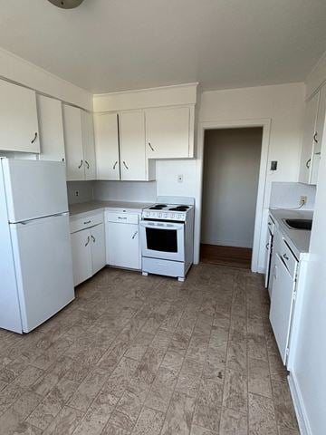 Halifax apartment for rent - A kitchen with white appliances and cabinets.