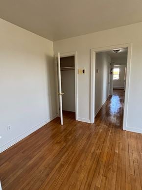 Halifax apartment for rent - A room with a white wall and a wooden floor.
