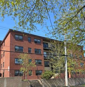 Halifax apartment for rent - A red brick building with a tree in front of it.