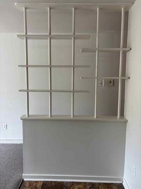 Halifax apartment for rent - A white shelving unit with glass doors and metal supports.