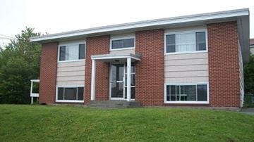 Halifax apartment for rent - A red brick house with a white door and windows.