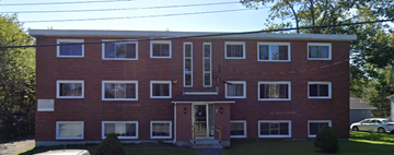 Halifax apartment for rent - A red brick building with a white door and windows.