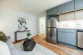 Atlanta apartment for rent - A modern kitchen with a refrigerator, oven, and cabinets.
