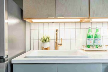 Atlanta apartment for rent - A kitchen with a white sink and a wooden cabinet.