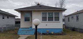 Gary house for rent - a small white house with blue steps in front of it