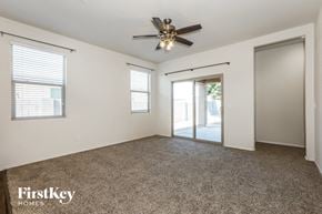 Florence house for rent - A spacious room with a ceiling fan and sliding glass doors.