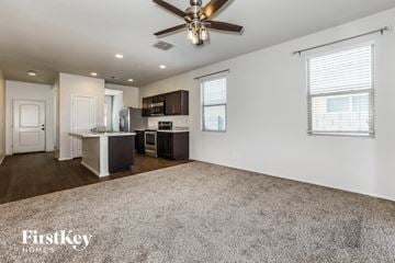 Florence house for rent - A spacious kitchen with a ceiling fan and a dining area with a table and chairs.