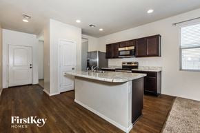 Florence house for rent - A kitchen with a white island and dark brown cabinets.