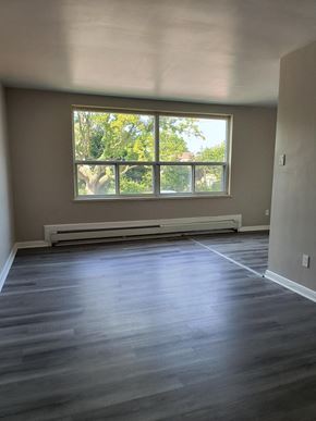 Brantford apartment for rent - A room with a window and a radiator on the wall.