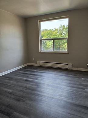 Brantford apartment for rent - A room with a window and a radiator on the floor.