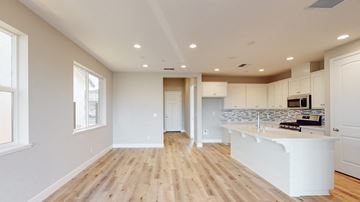 Chico apartment for rent - A kitchen with a white counter and wooden floors.