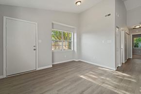 Havelock house for rent - A spacious room with light wood flooring and white walls.