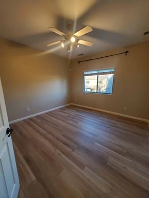 Chandler house for rent - a living room with hardwood floors and a ceiling fan