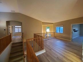 Chandler house for rent - a view of the top of a staircase in a home with wood floors