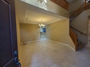 Chandler house for rent - a large empty living room with marble floors and a staircase