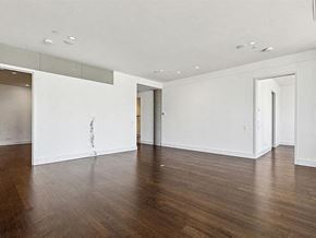 San Antonio apartment for rent - an empty living room with wood floors and white walls