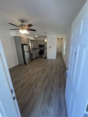 St. Louis apartment for rent - an empty living room and kitchen with wood floors and a ceiling fan