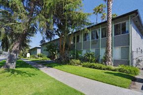 Los Angeles apartment for rent - A building with a green lawn in front of it.