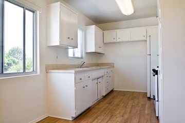 Los Angeles apartment for rent - A kitchen with white cabinets and a window.