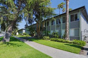 Los Angeles apartment for rent - A building with a green lawn in front of it.