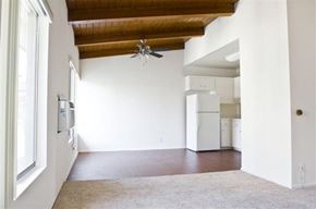Los Angeles apartment for rent - A room with a ceiling fan and a refrigerator in the corner.