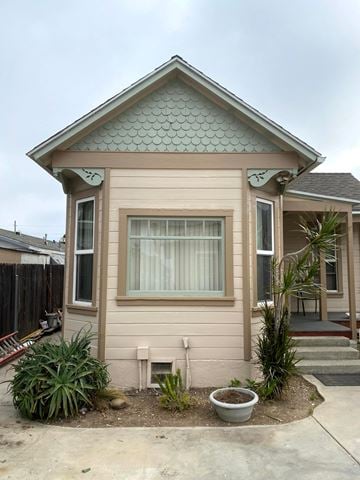 Ventura house for rent - a small tan house with a porch and a yard with plants