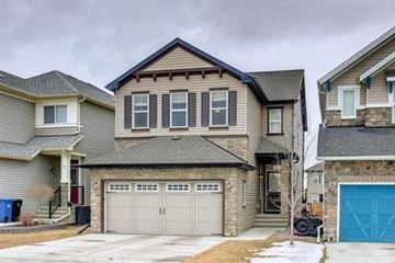 Calgary house for rent - a house with a garage and a blue garage door