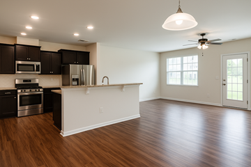 Indian Land house for rent - A kitchen with dark wood cabinets and a white island.
