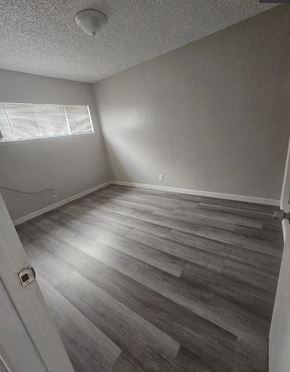 Ontario apartment for rent - A room with wooden flooring and a window.