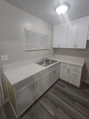 Ontario apartment for rent - A kitchen with white cabinets and a sink.