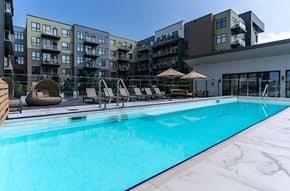 Saskatoon apartment for rent - A swimming pool in front of apartment buildings.