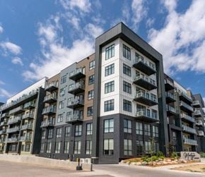 Saskatoon apartment for rent - A modern multi-story apartment building with balconies on each floor.
