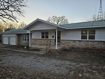 Mcloud house for rent - a white house with a porch and a gravel driveway