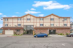 Hawthorne apartment for rent - A blue car is parked in front of a building with the number 1805 on it.