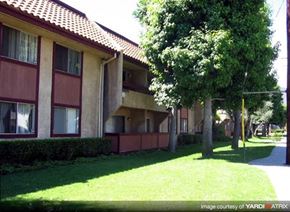 Azusa apartment for rent - A building with a red roof and a green lawn in front.